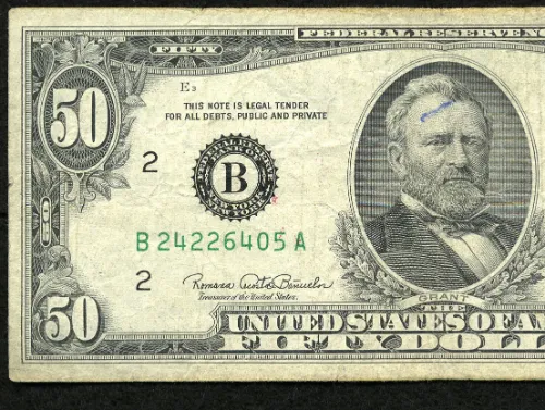 An ink mark is found on Grant's forehead, while a few red ink droplets have also landed on this scarce $50.